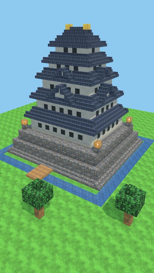 石垣と堀の上に、白壁と黒い瓦屋根が5段に重なる天守
